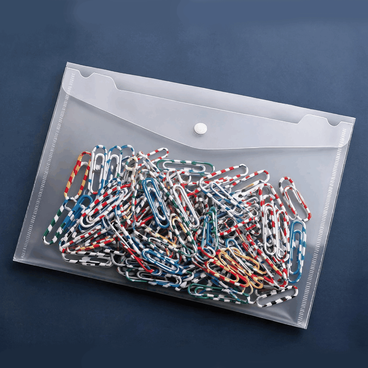 A4 Snap-Closure File Pouch in clear frosted plastic with a white snap button, filled with colourful patterned paper clips