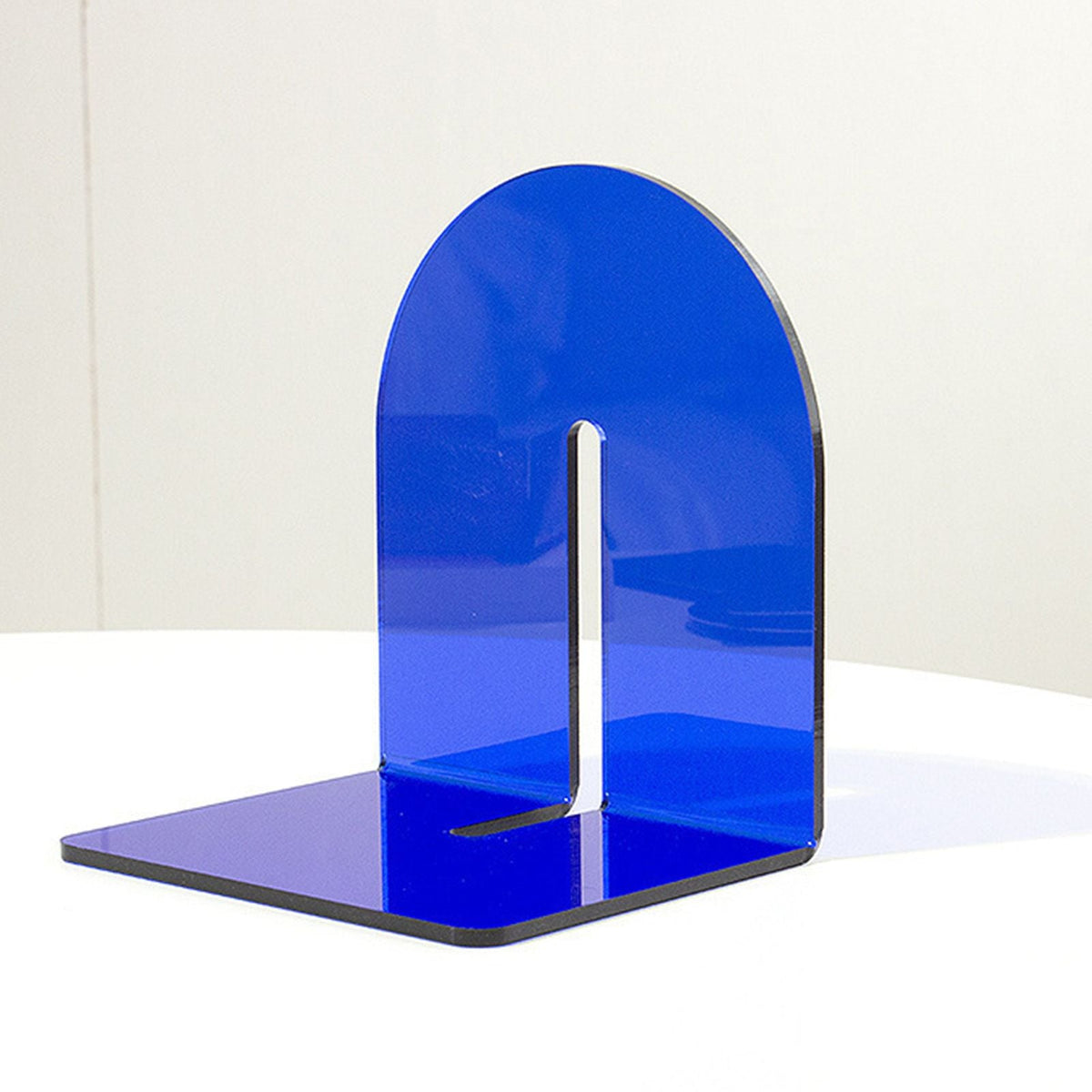 Acrylic Book End in translucent blue glossy acrylic, with a thick L-shaped base and rounded upright panel.