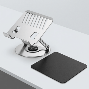 Adjustable aluminum alloy laptop stand in polished silver metal with an open slotted tray and round rotating base, paired with a black mouse pad