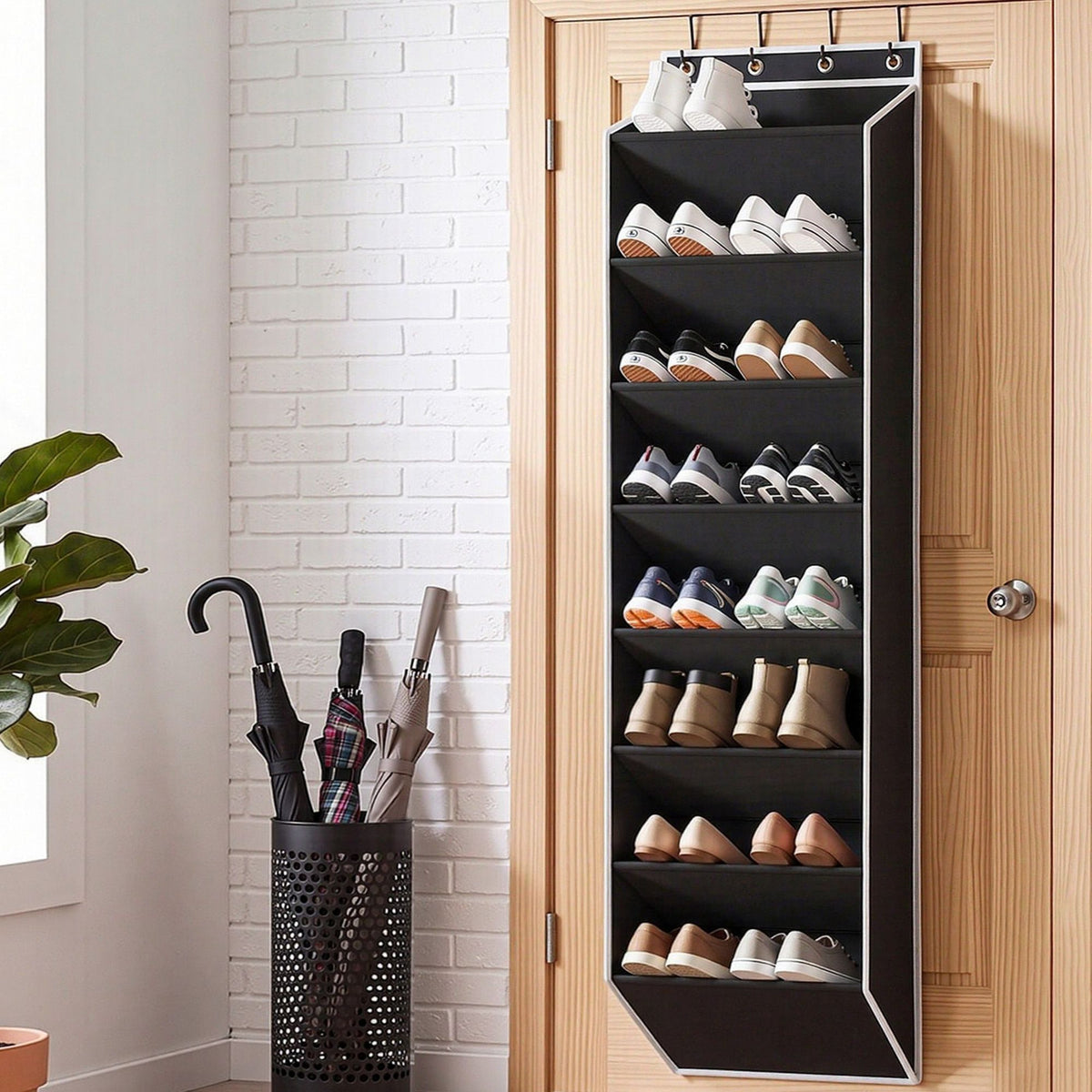 Artiss Over Door Shoe Organiser in black fabric with white trim, featuring eight tiers filled with shoes and hanging hooks.