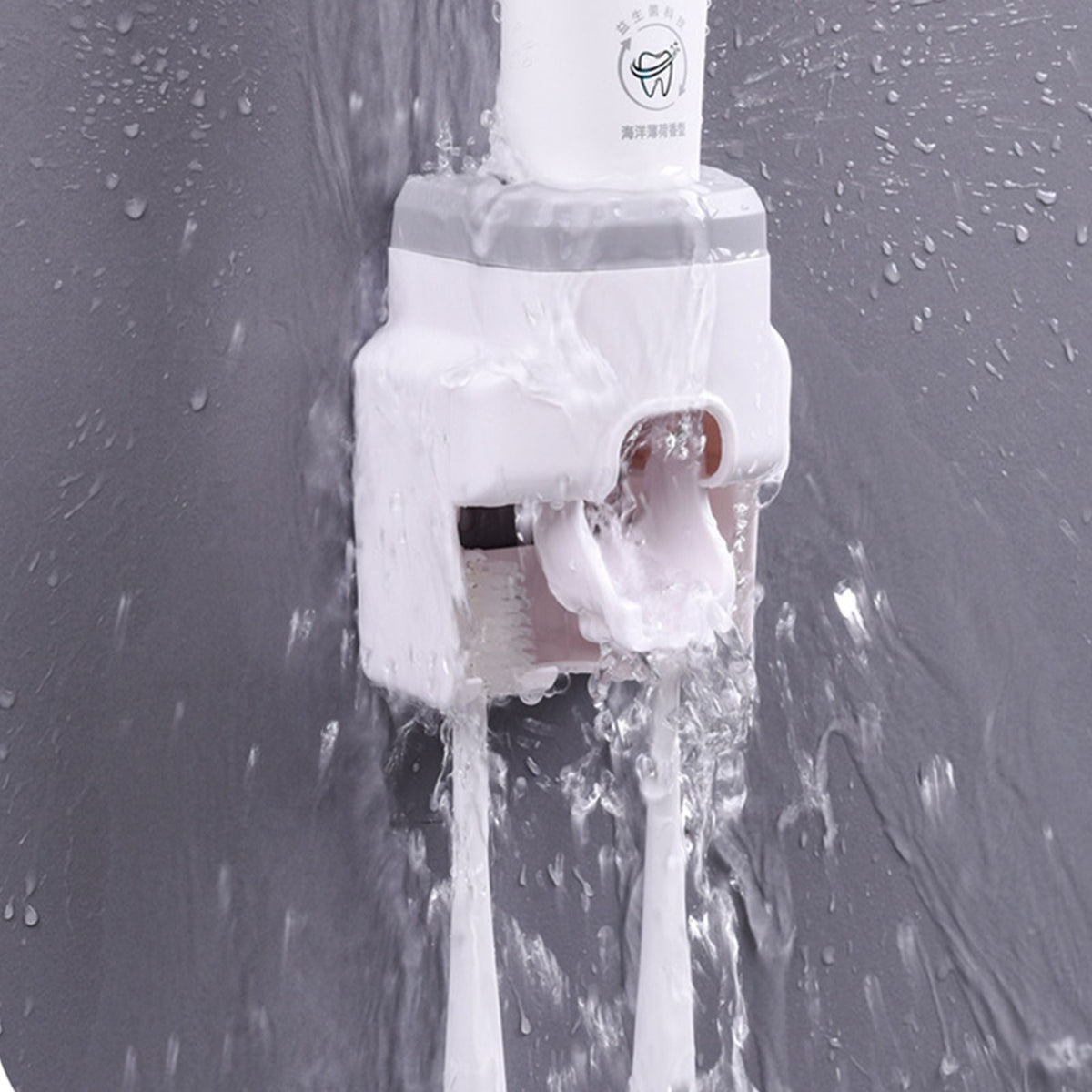 Automatic Toothpaste Dispenser in white plastic with a built-in toothbrush holder, shown releasing toothpaste as water runs over it