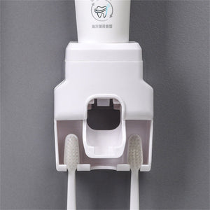 Automatic Toothpaste Dispenser in white plastic with an integrated holder for two toothbrushes and a central dispensing port