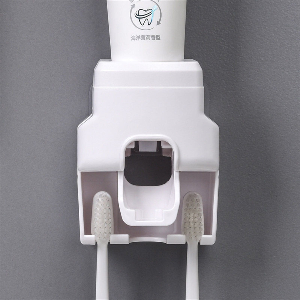 Automatic Toothpaste Dispenser in white plastic with an integrated holder for two toothbrushes and a central dispensing port