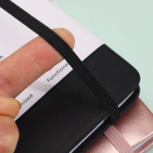 Black Address Book with a smooth black hardcover and elastic strap, shown open with lined contact pages and a ribbon bookmark