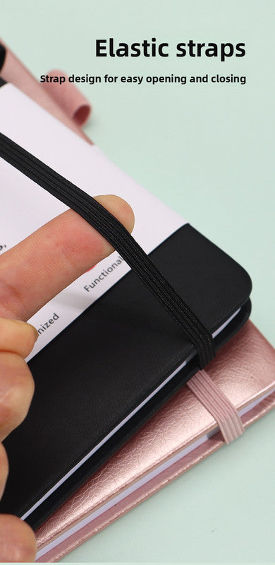 Black Address Book with a smooth black hardcover and elastic strap, shown open with lined contact pages and a ribbon bookmark