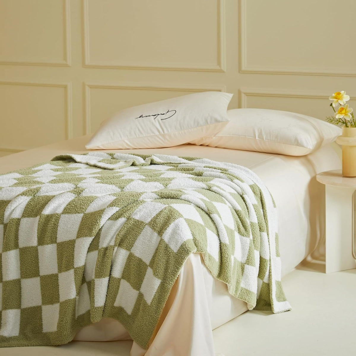 Knitted checkerboard throw in white and muted olive green, with a plush textured surface and bold square pattern; Black and White Premium Knitted Checkerboard