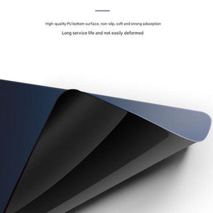 Mouse pad with a blue-to-black gradient silicone surface and a thick, flexible black non-slip bottom.