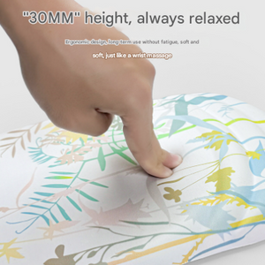Black Ergonomic Mouse Pad with a floral pattern, flat cushioned surface and raised wrist support pressed by a hand