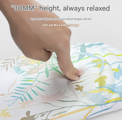 Black Ergonomic Mouse Pad with a floral pattern, flat cushioned surface and raised wrist support pressed by a hand