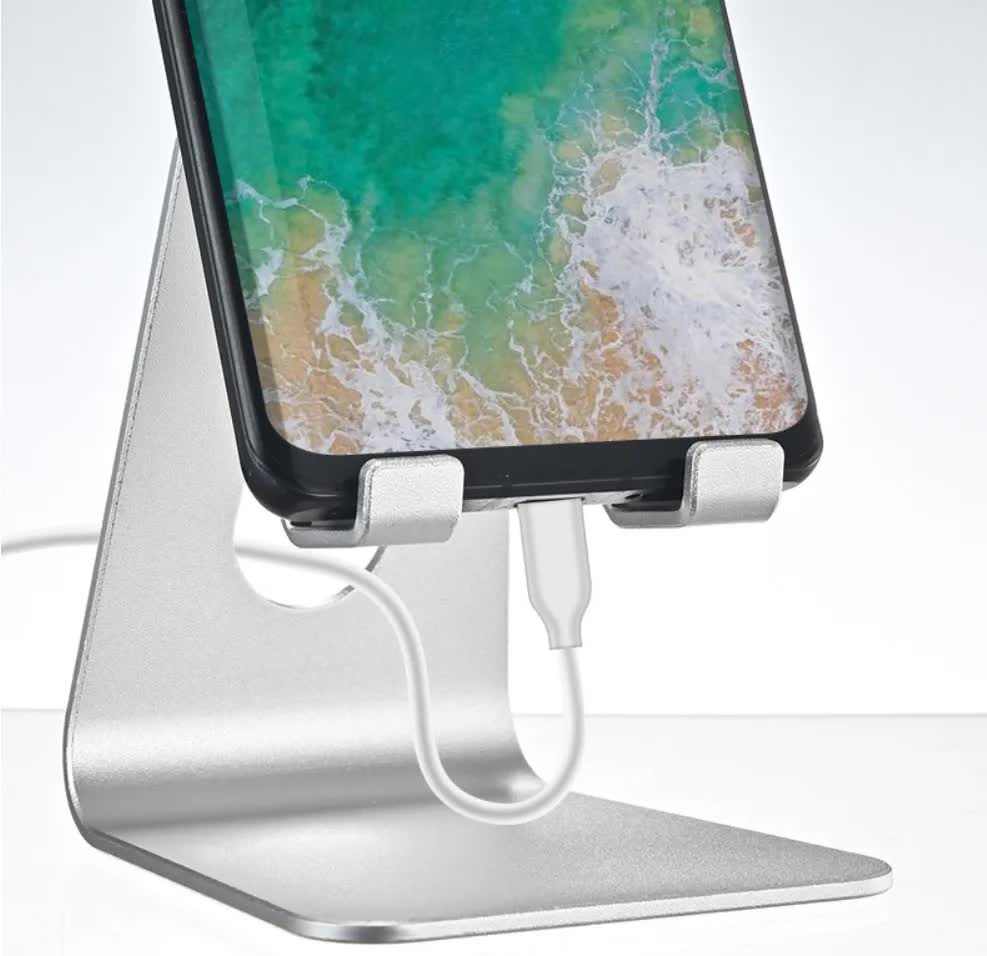Black Foldable Aluminum Alloy phone stand shown supporting a smartphone, with a hinged frame and charging cable access