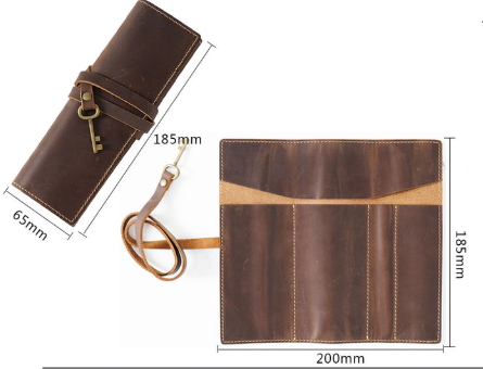 Pencil roll case in Black Genuine Crazy Horse Leather with stitched compartments, wraparound strap, and key charm.