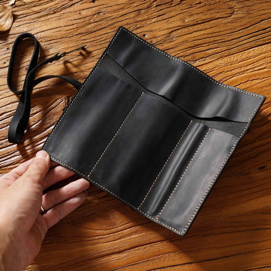 Black Genuine Crazy Horse Leather pencil roll with stitched compartments, protective flap and attached wraparound tie strap