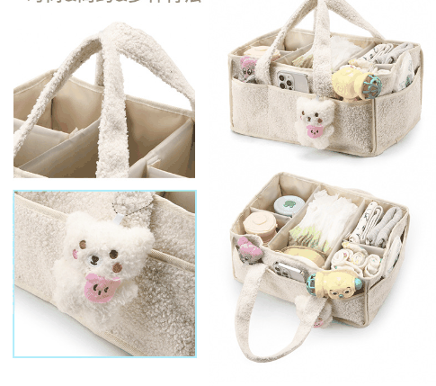 Black Large Plush Nappy Caddy described as a soft teddy-fleece organiser with dividers, carry handles and a bear-face detail; pictured in cream.