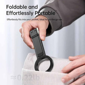 Black Magnetic Phone Stand in matte black aluminium, with a slim foldable body and circular magnetic ring tucked into a pocket
