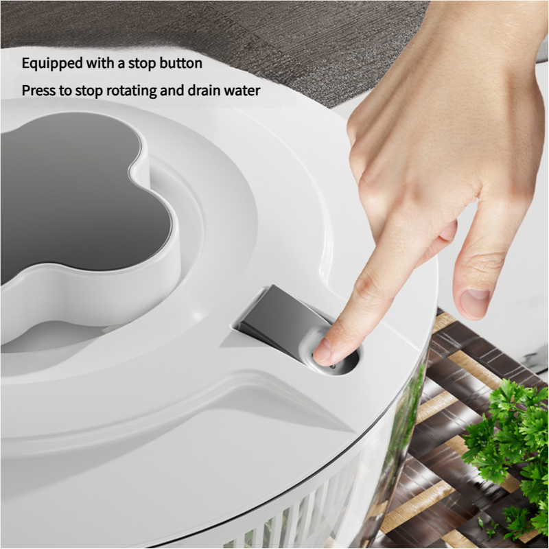 Black Manual Salad Spinner with a light grey plastic lid, sculpted grip and visible stop-button for water drainage