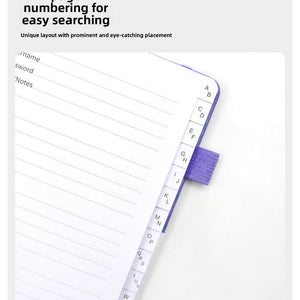 Black Password Log Book opened to lined entry pages, with visible A–Z alphabetical index tabs and a purple elastic loop