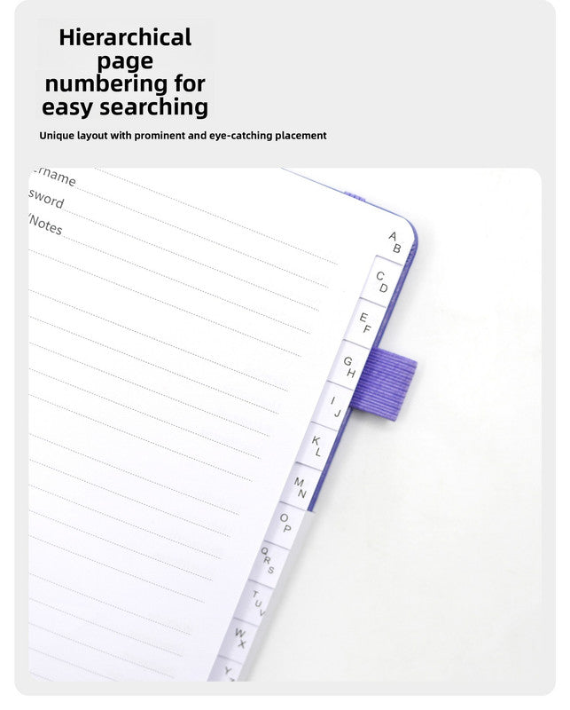 Black Password Log Book opened to lined entry pages, with visible A–Z alphabetical index tabs and a purple elastic loop