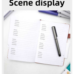 Black Password Log Book opened to lined website and login detail pages, with alphabetic index tabs and a pen loop