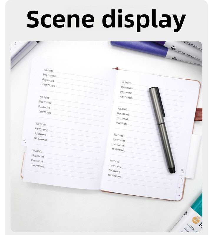 Black Password Log Book opened to lined website and login detail pages, with alphabetic index tabs and a pen loop