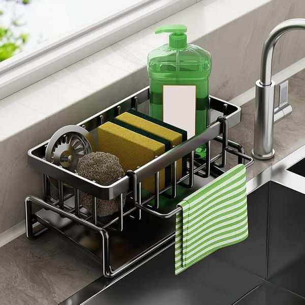 Black Sink Side Storage Rack in black metal with compartments for sponges and soap, plus hooks holding a striped cloth