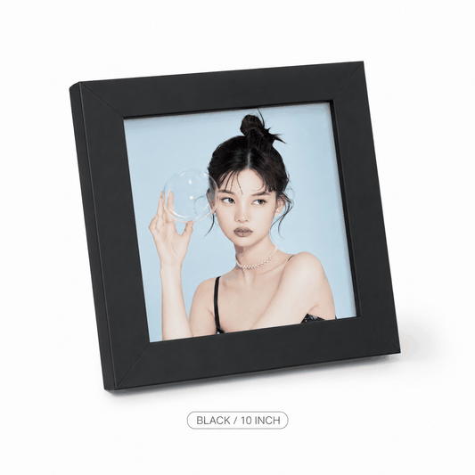 Black square 6-inch photo frame in matte black aluminium, with a broad minimalist border and clear front displaying a portrait
