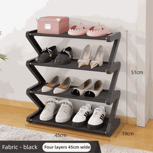 Black Stable Z-Shaped shoe rack with four black fabric tiers and a zigzag frame, displaying shoes and slippers