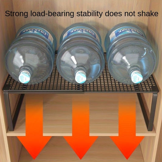 Black White adjustable mesh storage shelf with a black metal frame and slatted mesh top supporting three large water bottles