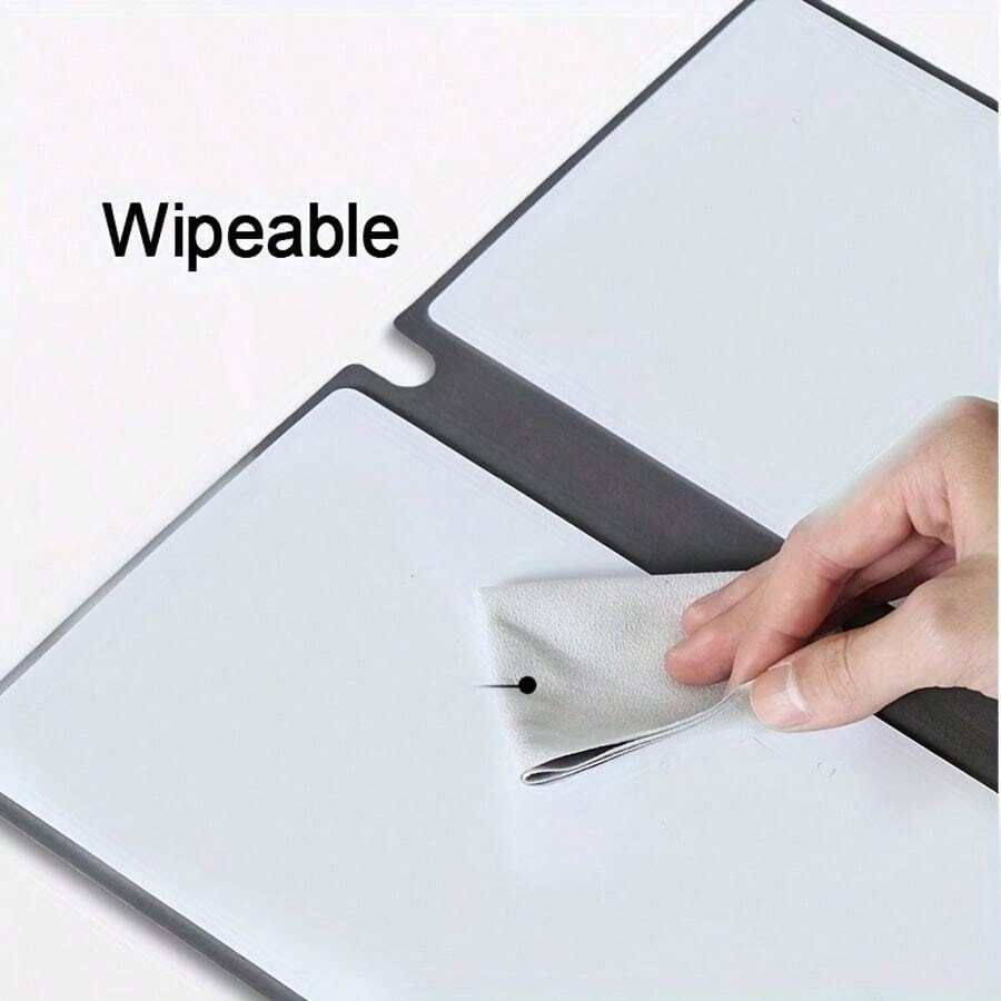 Blue A4 PU Leather reusable whiteboard notebook with a smooth wipeable surface being cleaned with a cloth