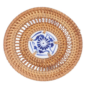 Blue and White Porcelain Coaster with a blue floral porcelain center and natural tan woven rattan rim