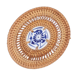 Blue and White Porcelain Coaster with a blue floral porcelain center and a natural tan woven rattan border