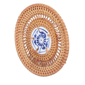 Blue and White Porcelain Coaster with tan woven rattan border and a central blue floral porcelain tile