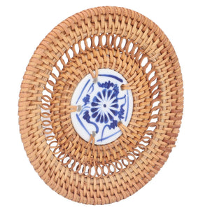Blue and White Porcelain Coaster with a natural tan woven rattan surround and a blue floral porcelain center