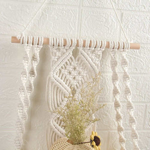 Boho Macrame Wall Hanging Shelf in natural white cotton rope with a light wooden dowel and intricate knotted fringe