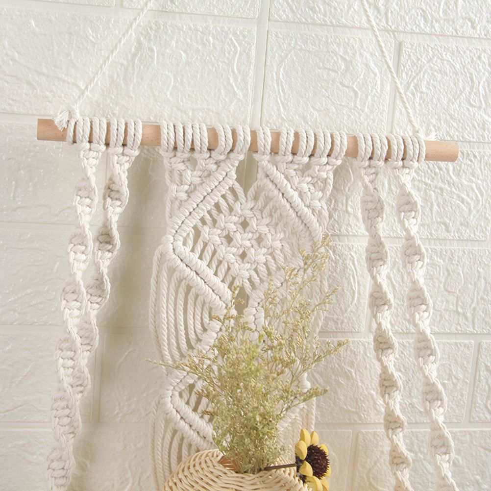 Boho Macrame Wall Hanging Shelf in natural white cotton rope with a light wooden dowel and intricate knotted fringe