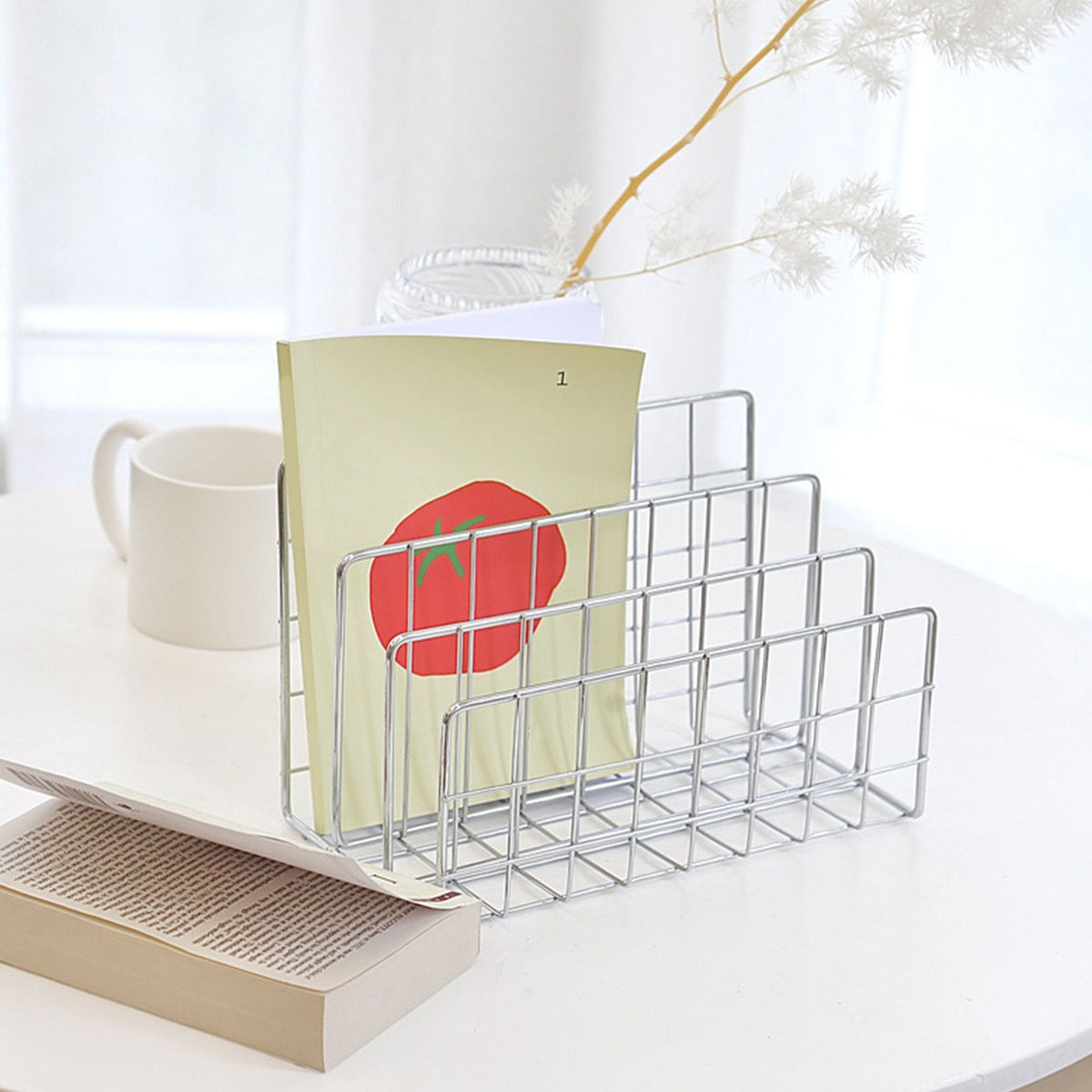 Book Sorter File Magazine rack in silver metal wire with stepped dividers holding a pale green folder