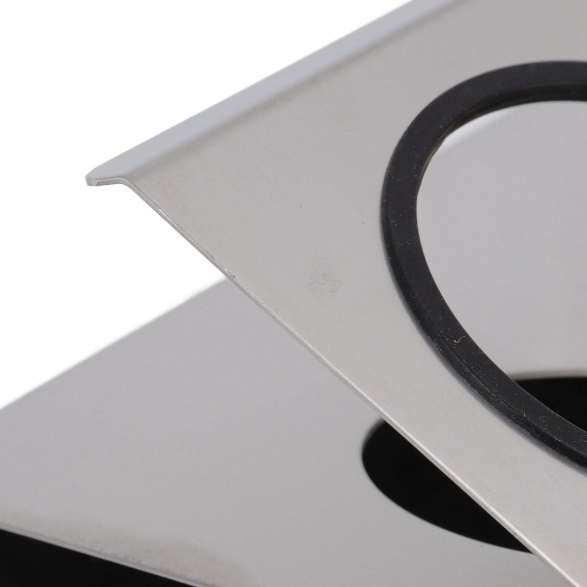 Bottle Drain Drying Rack with a silver stainless steel plate and black circular silicone-lined bottle opening
