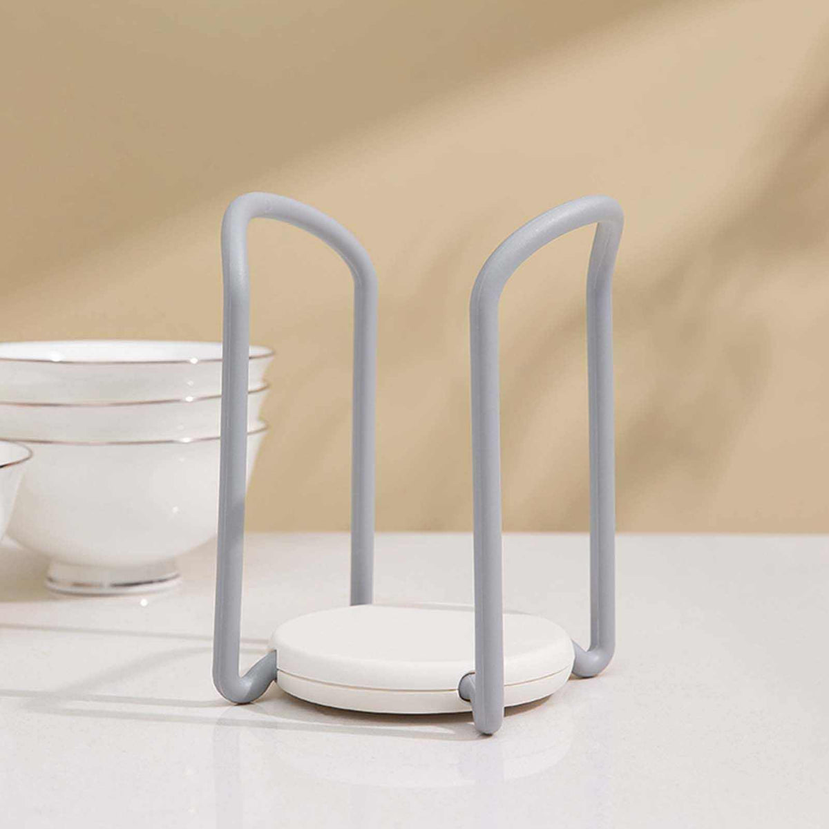 Bowl Organizer Multiple Functional retractable dish holder in grey and white plastic, with tall looped sides and a round base