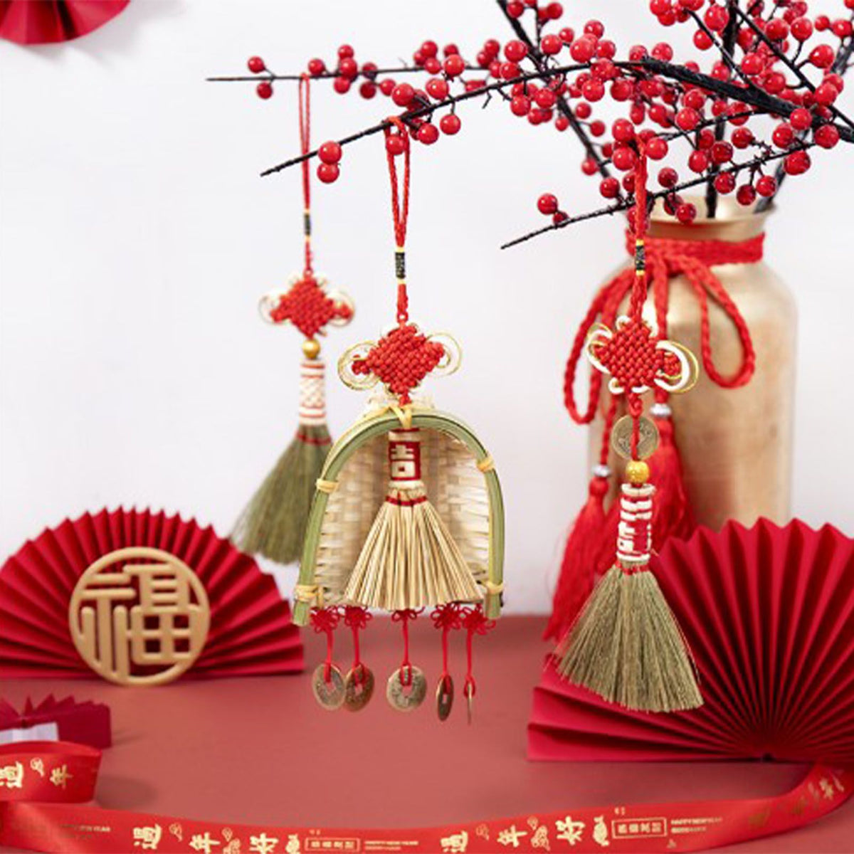 Broom Dustpan Decor ornament with a woven golden mini broom, curved bamboo dustpan, red knots and hanging coin charms