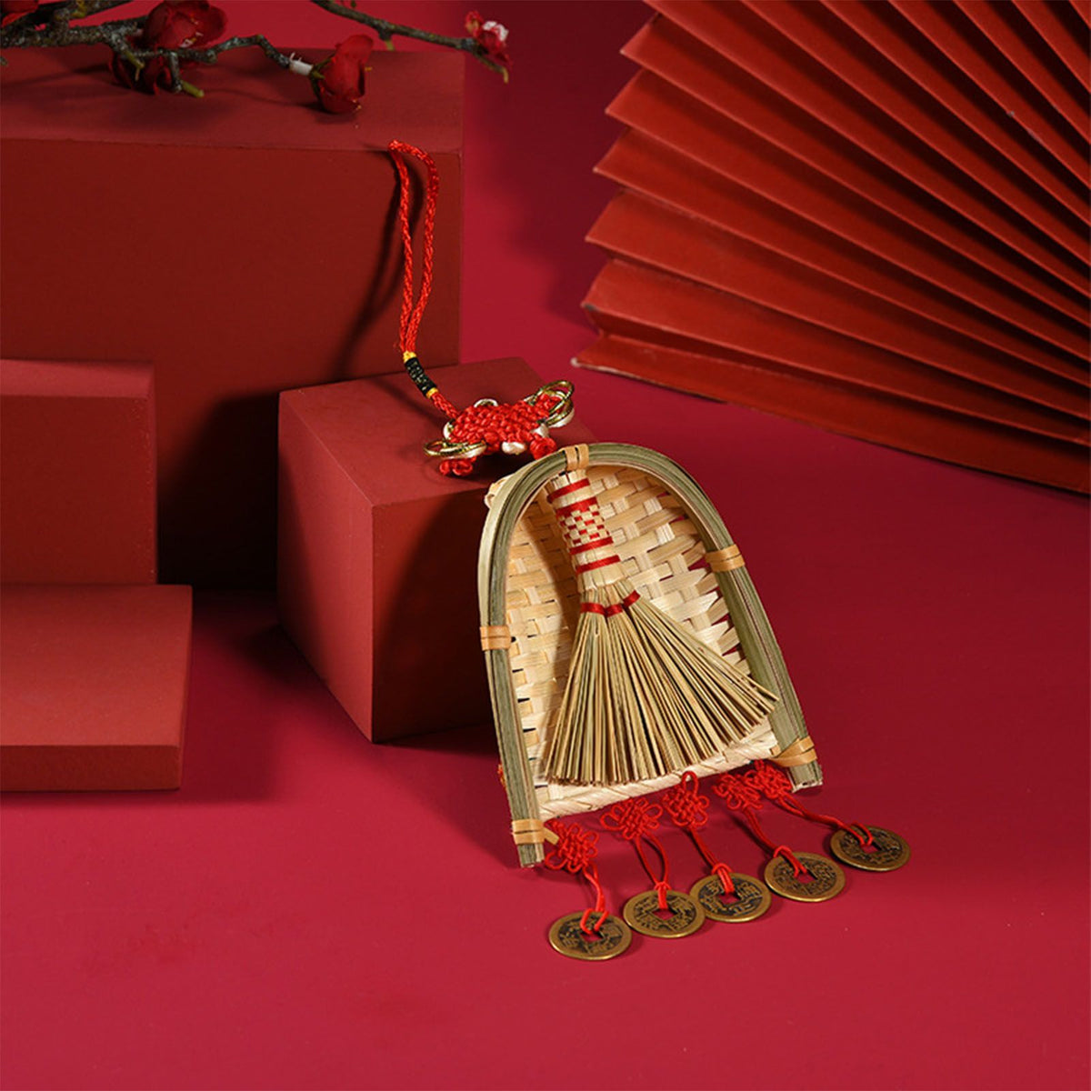 Broom Dustpan Decor ornament with a woven golden straw broom, bamboo-toned dustpan, red tassels and coin charms