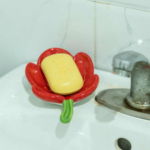 Ceramic Leaf Soap Box in glossy red ceramic, shaped like a flower with a green stem, holding yellow soap