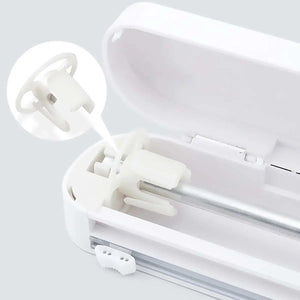 Cling Film Cutter Box in white ABS plastic with built-in sliding blade and suction cup base for secure countertop use