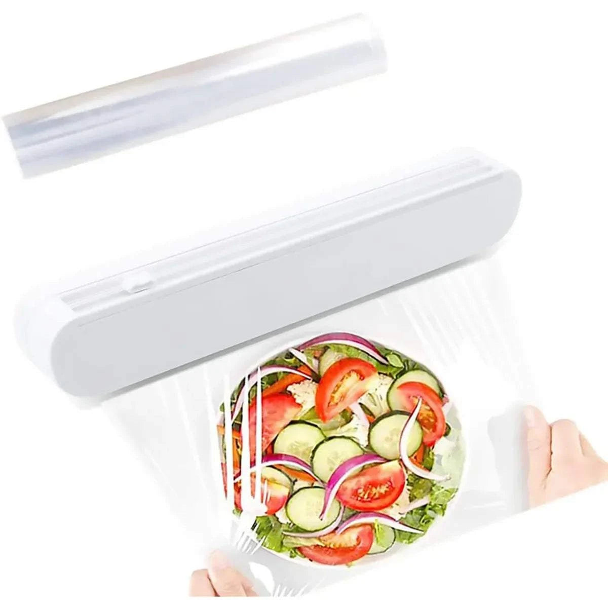 White ABS plastic Cling Film Cutter Box with built-in sliding blade and suction cup base cutting clear cling film over a salad bowl