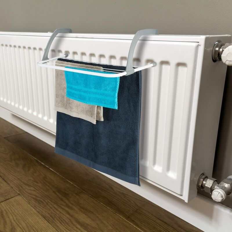Clothes Dryer radiator airer with a white metal frame, grey adjustable hooks and multiple crossbars holding three towels
