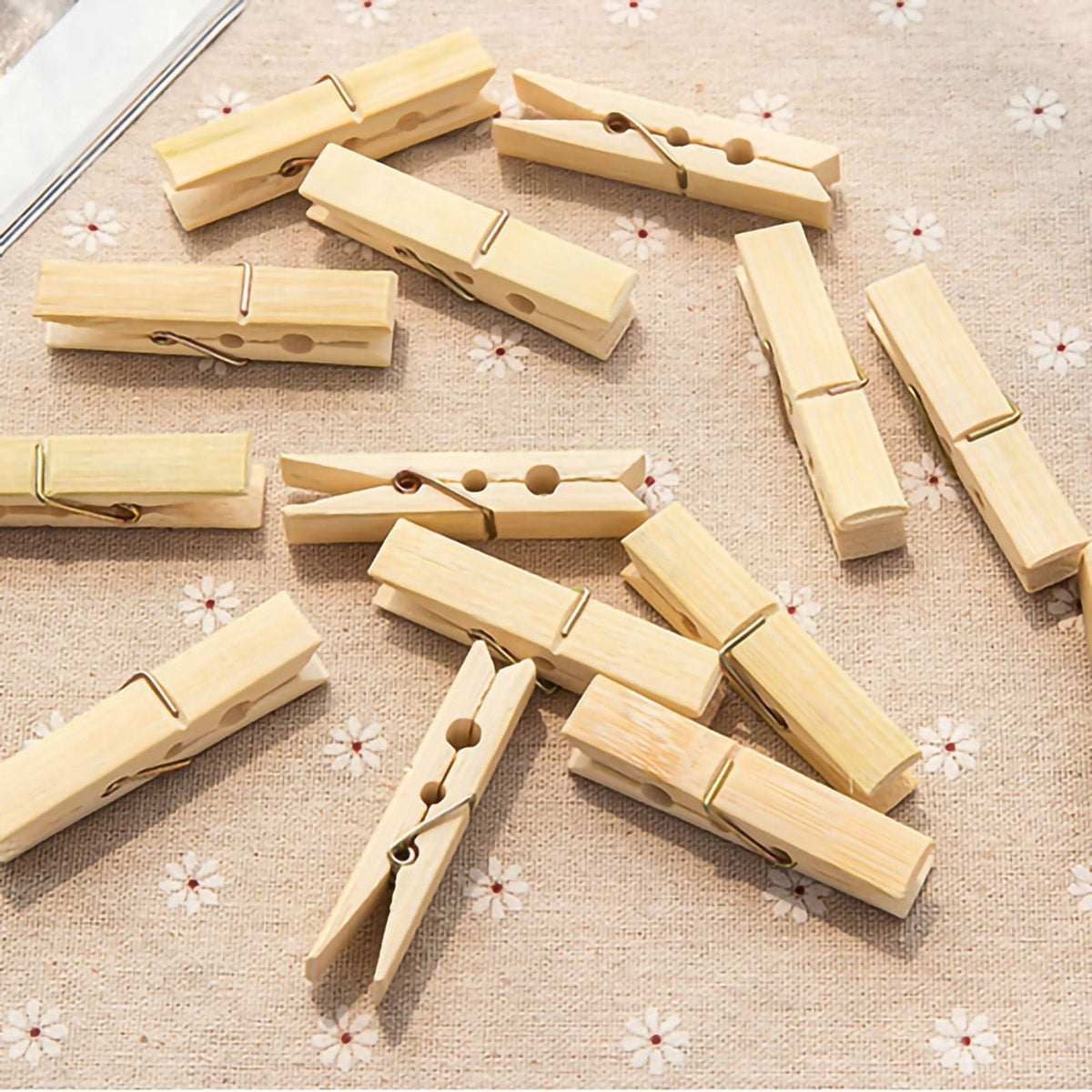 Clothes Pegs made from pale natural bamboo with metal springs, shown as multiple sturdy wooden clips