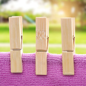 Clothes Peg in natural light bamboo with metal spring clips, shown securing a purple textured towel