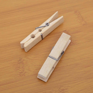Clothes Pegs in natural pale bamboo with silver metal springs and a simple, smooth wooden finish