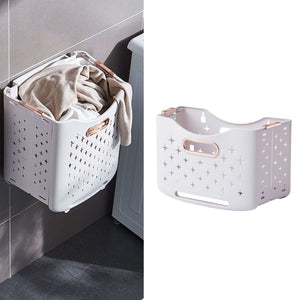 Collapsible Laundry Basket in pale pink plastic with rose gold handles, star-shaped ventilation holes and folding sides.
