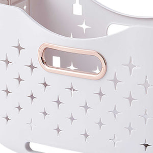 Collapsible Laundry Basket in pale pink plastic with rose gold-edged handles and raised star-shaped ventilation cutouts