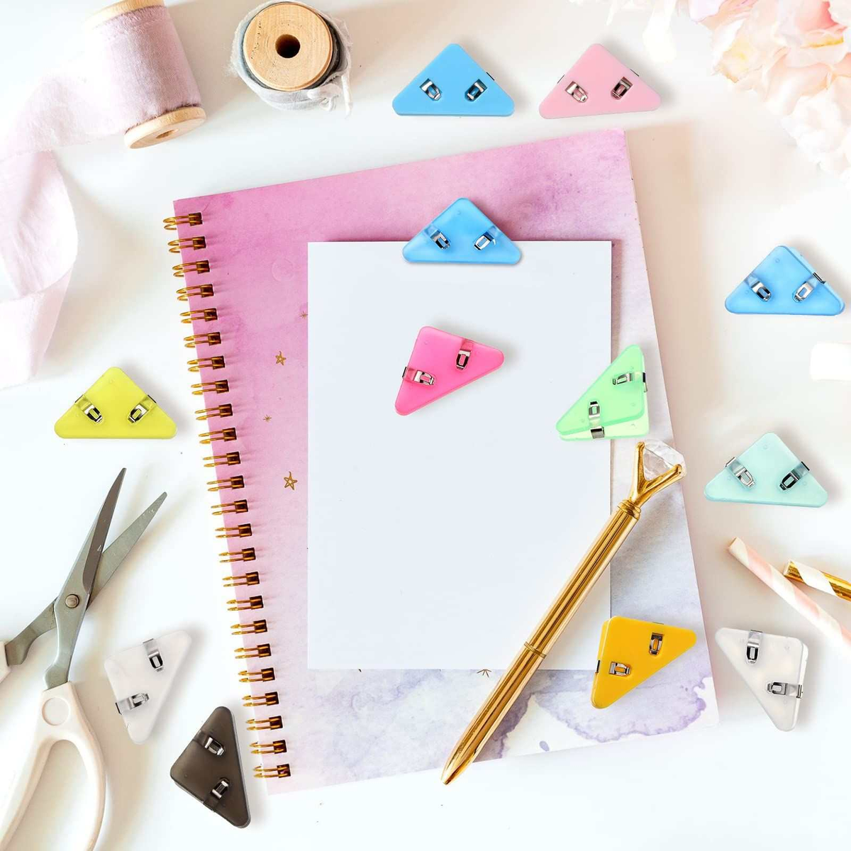Corner Clip Triangle page clips in assorted pastel plastic colours, with triangular shapes and small metal fasteners.