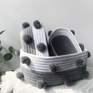 Cotton rope basket set in grey and white, with ribbed woven bands and soft grey pom-pom accents
